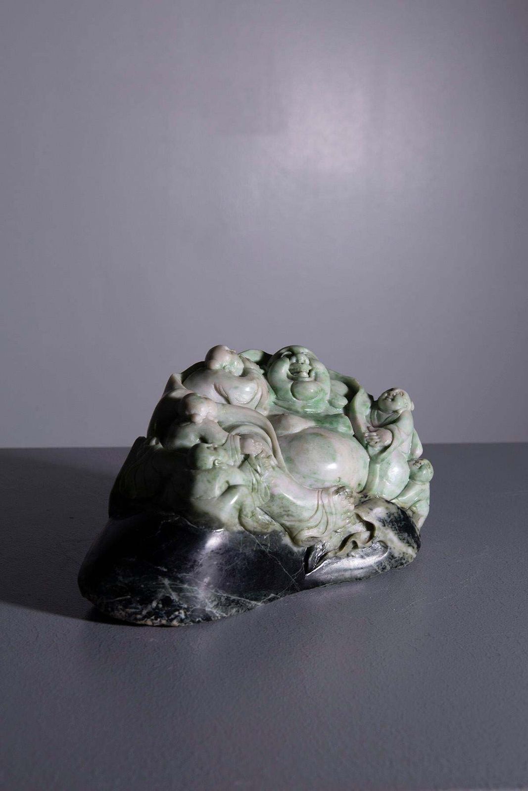 Sculpture Of Buddha Surrounded By Children In Jade Root photo for sale