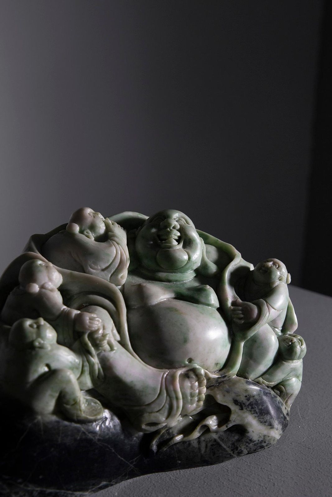 Sculpture Of Buddha Surrounded By Children In Jade Root photo 927.0