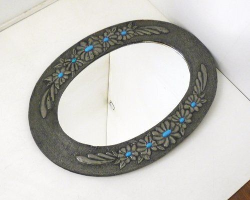photo vintage Oval Wall Mirror With Pewter Frame Decorated With Large Flowers In Relief, With Turquoise Heart, 1950s