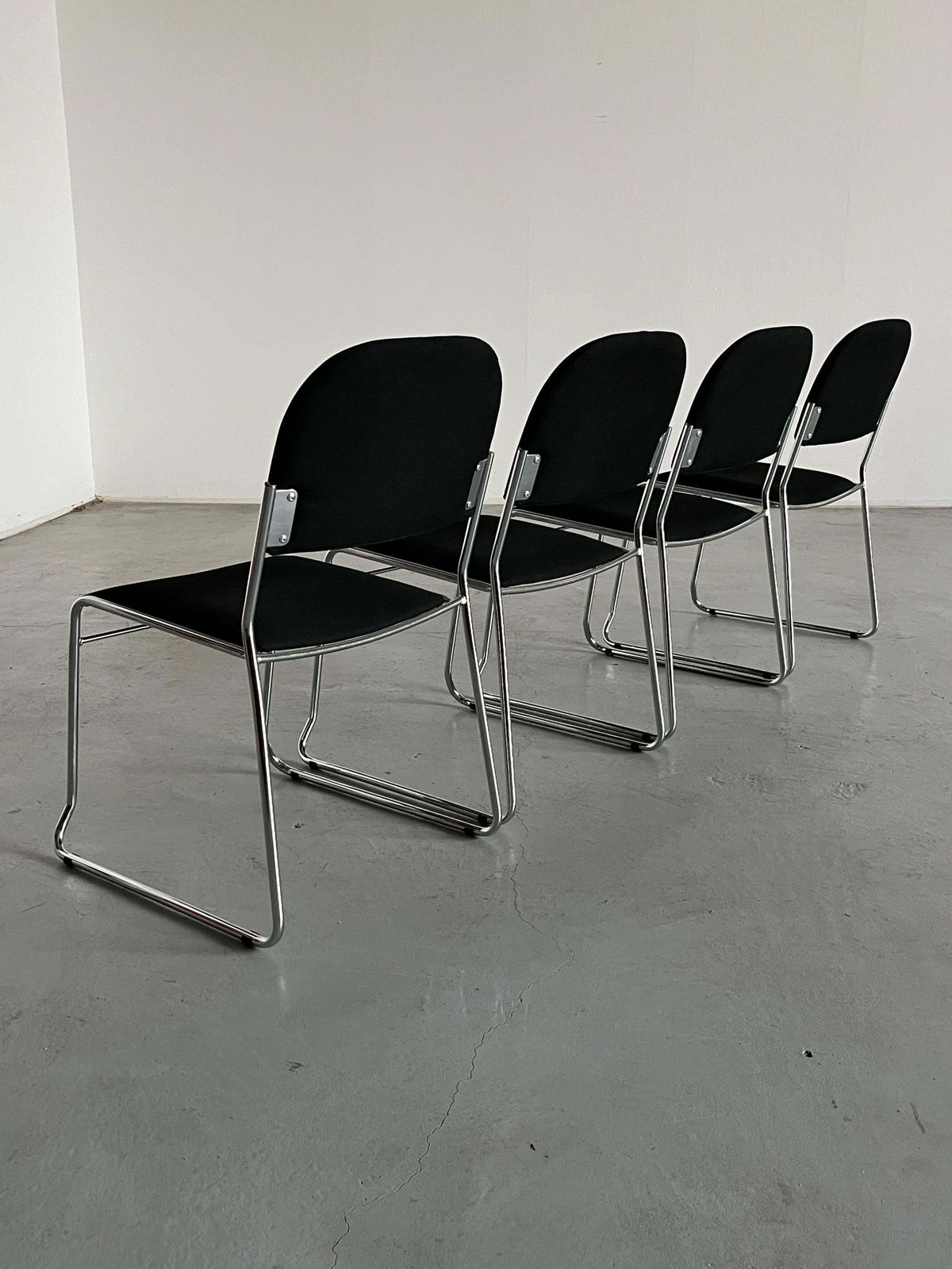 photo furniture Set Of 4 Minimalist Dining Chairs In Black Fabric And Chromed Steel, Stackable