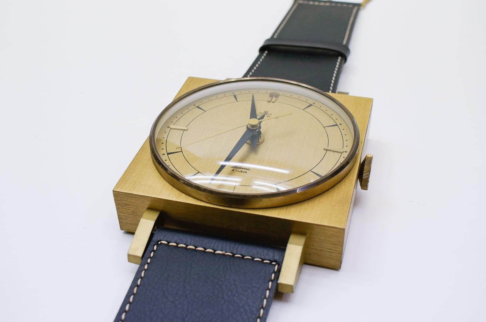 Midcentury Wall Clock In The Form Of A Wristwatch In Leather And Brass, Germany photo Home Decor