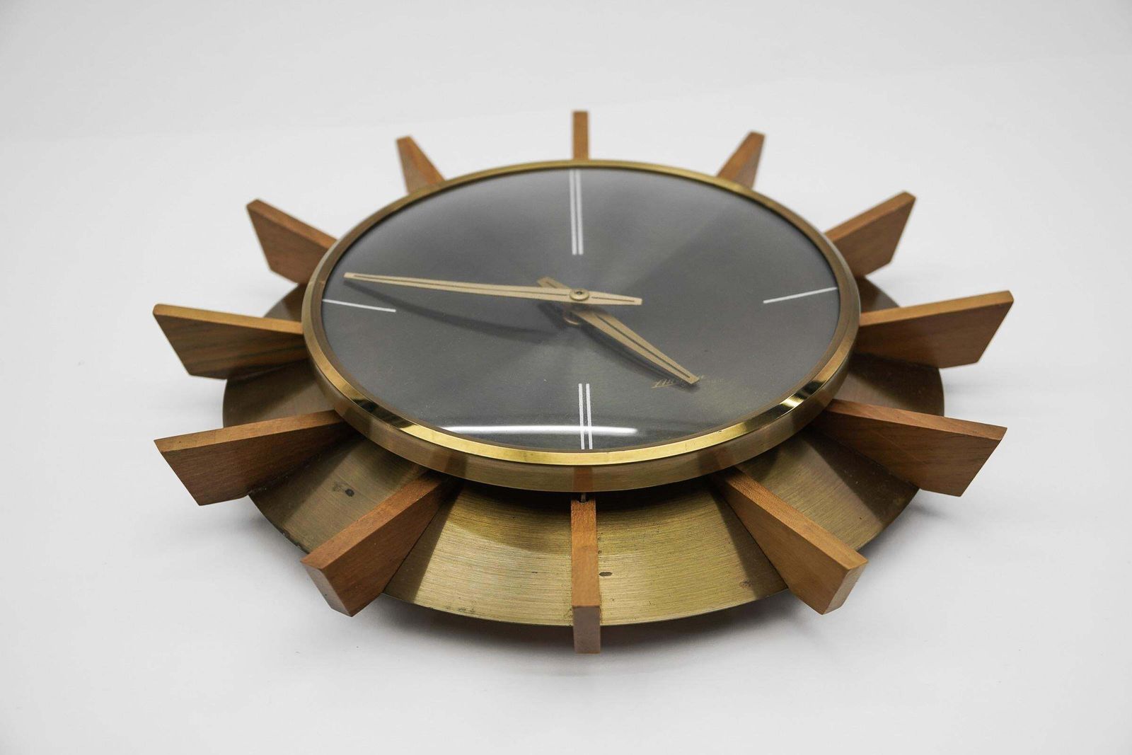Mid Century Modern Brass And Wood Sunburst Wall Clock By Atlanta Electric photo for sale