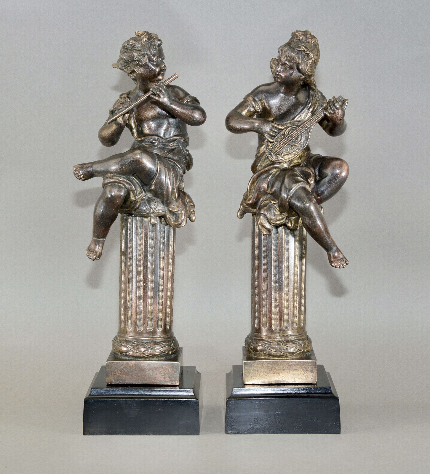 A Pair Of Mid 19th Century Musical Cherubs Cast In Bronze.