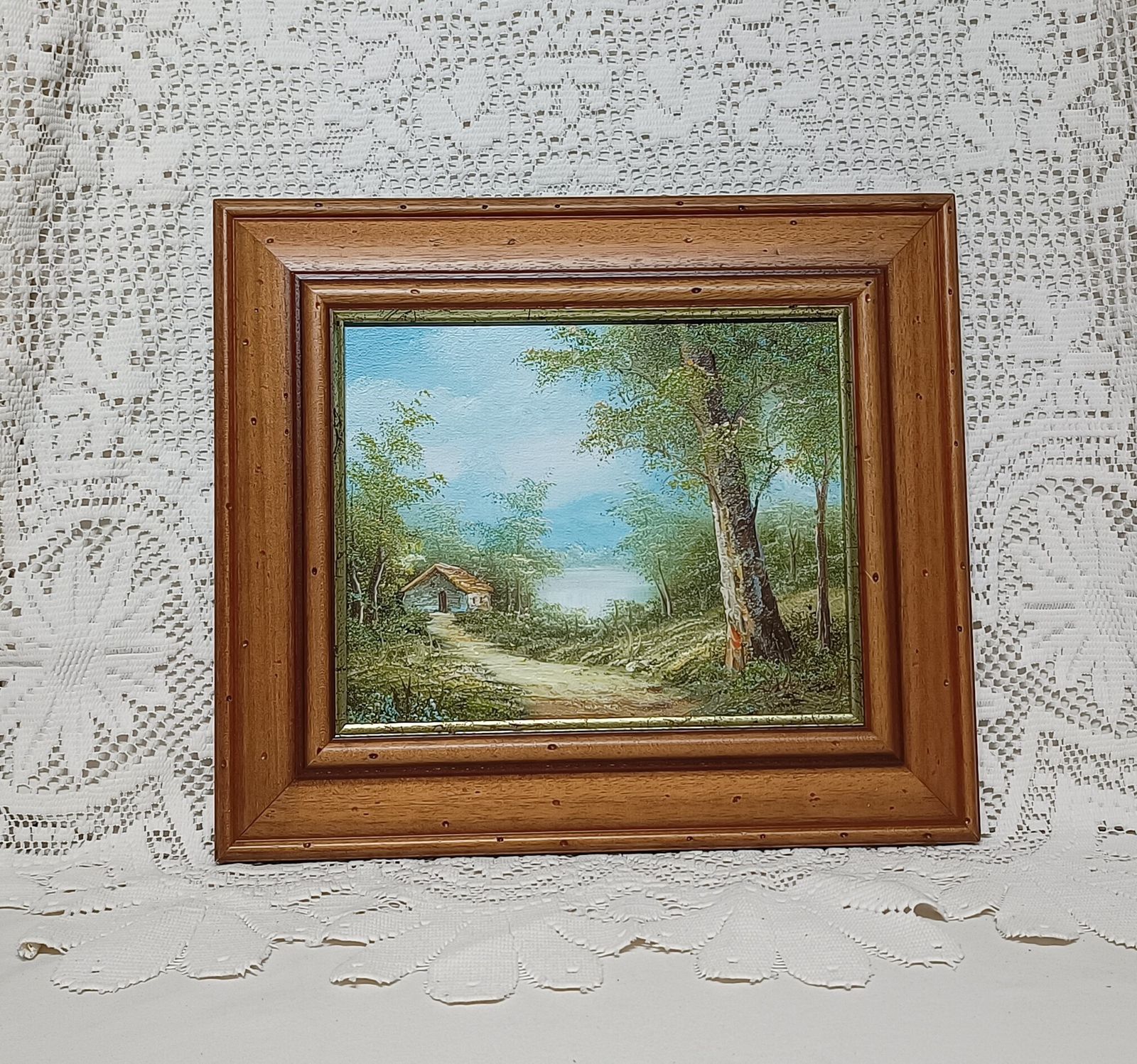 Decorative Oil Painting Mountain Lakeside Cabin Vista Framed In Wooden Frame. photo for sale