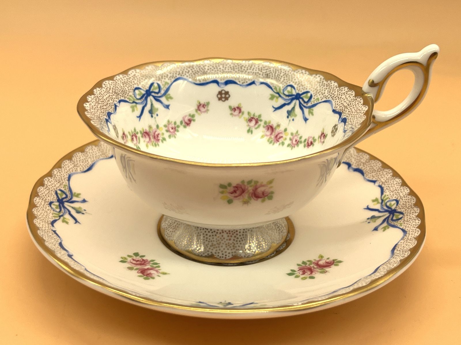 Wedgwood China Harlequin Collection Ribbon And Roses Design Footed Tea Cup And Saucer Duo.