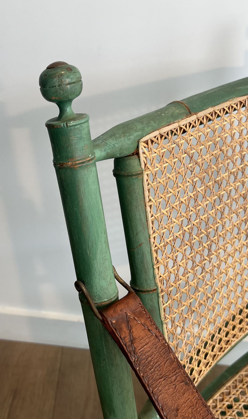 photo vintage Pair Of Folding Safari Chairs In Weathered Faux Bamboo Style With Caned Backs And Seats And Leather Armrests