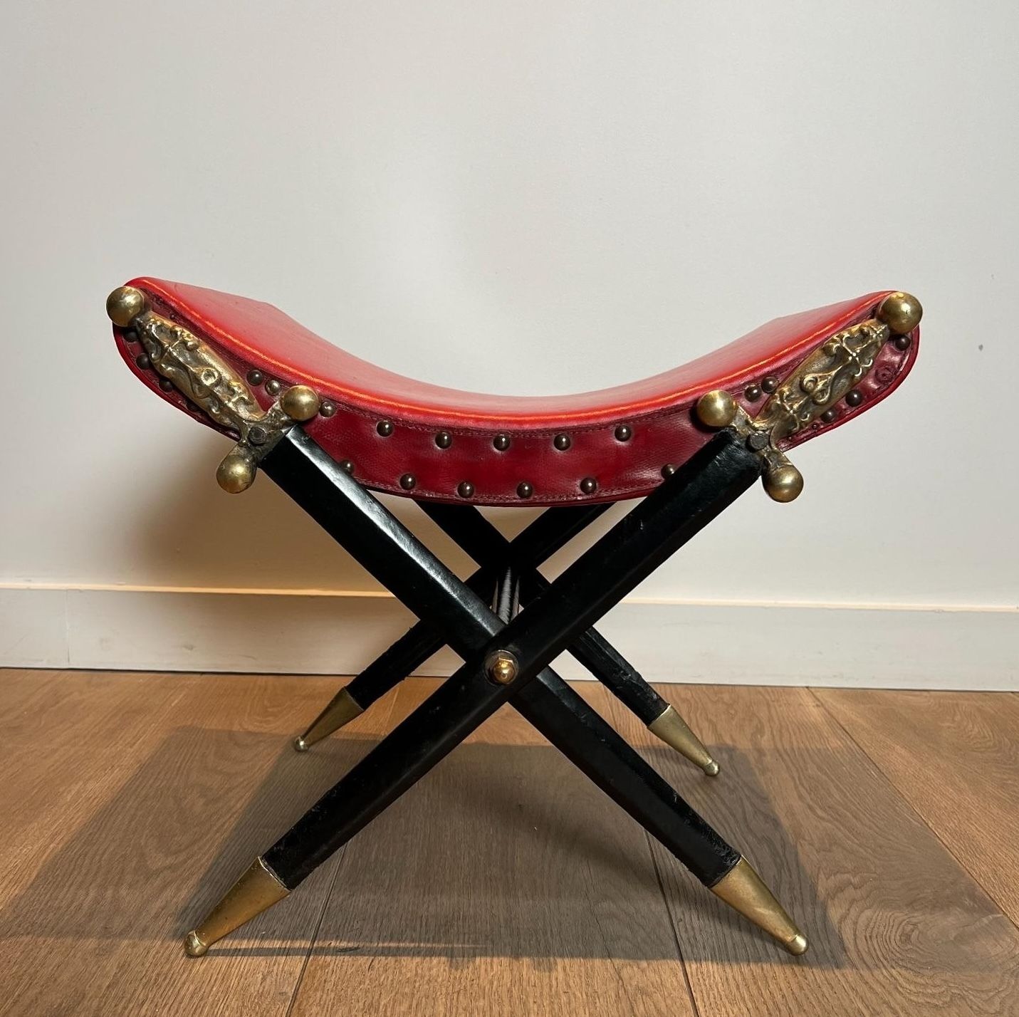 Neoclassical Style Curule Stool In Red Leather And Decorated With Crossed Swords In Bronze And Metal Covered In Black Leather photo furniture