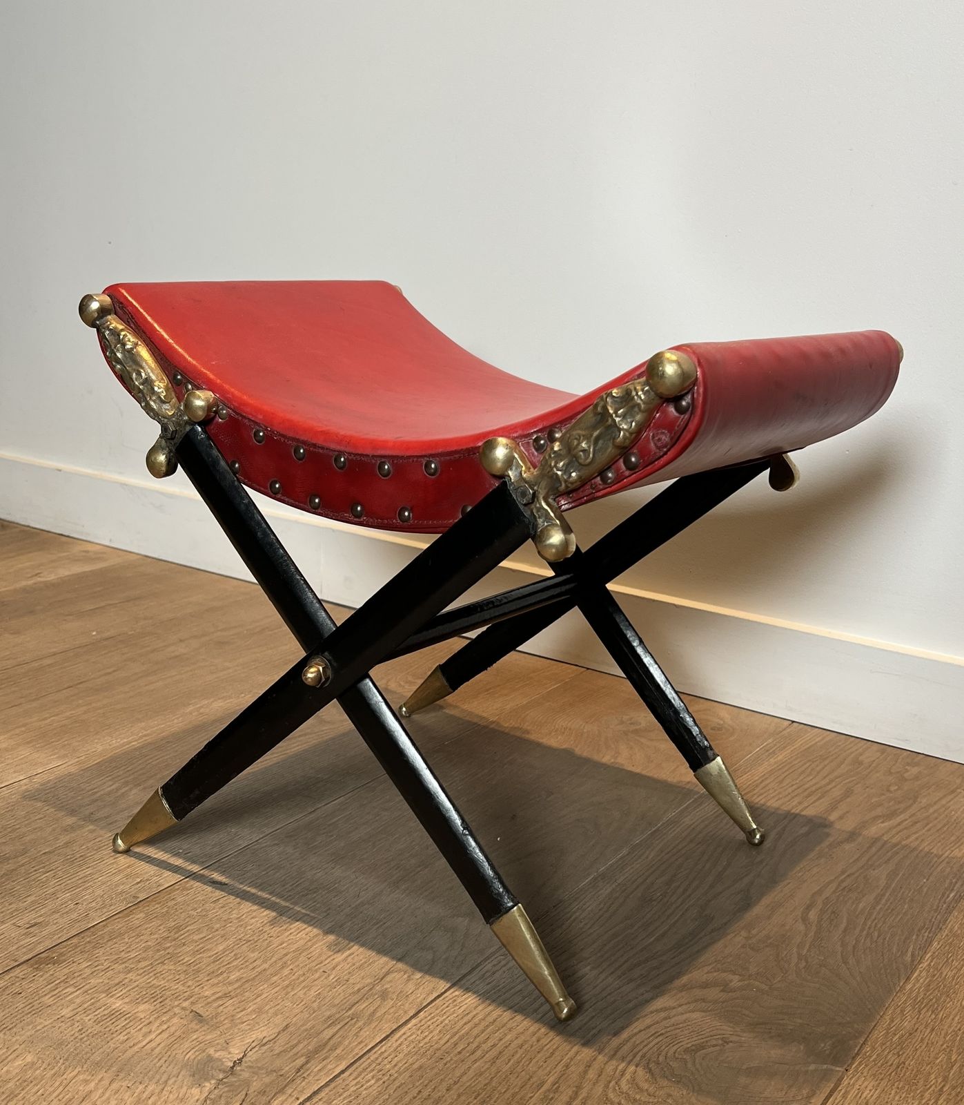 Neoclassical Style Curule Stool In Red Leather And Decorated With Crossed Swords In Bronze And Metal Covered In Black Leather photo Furniture