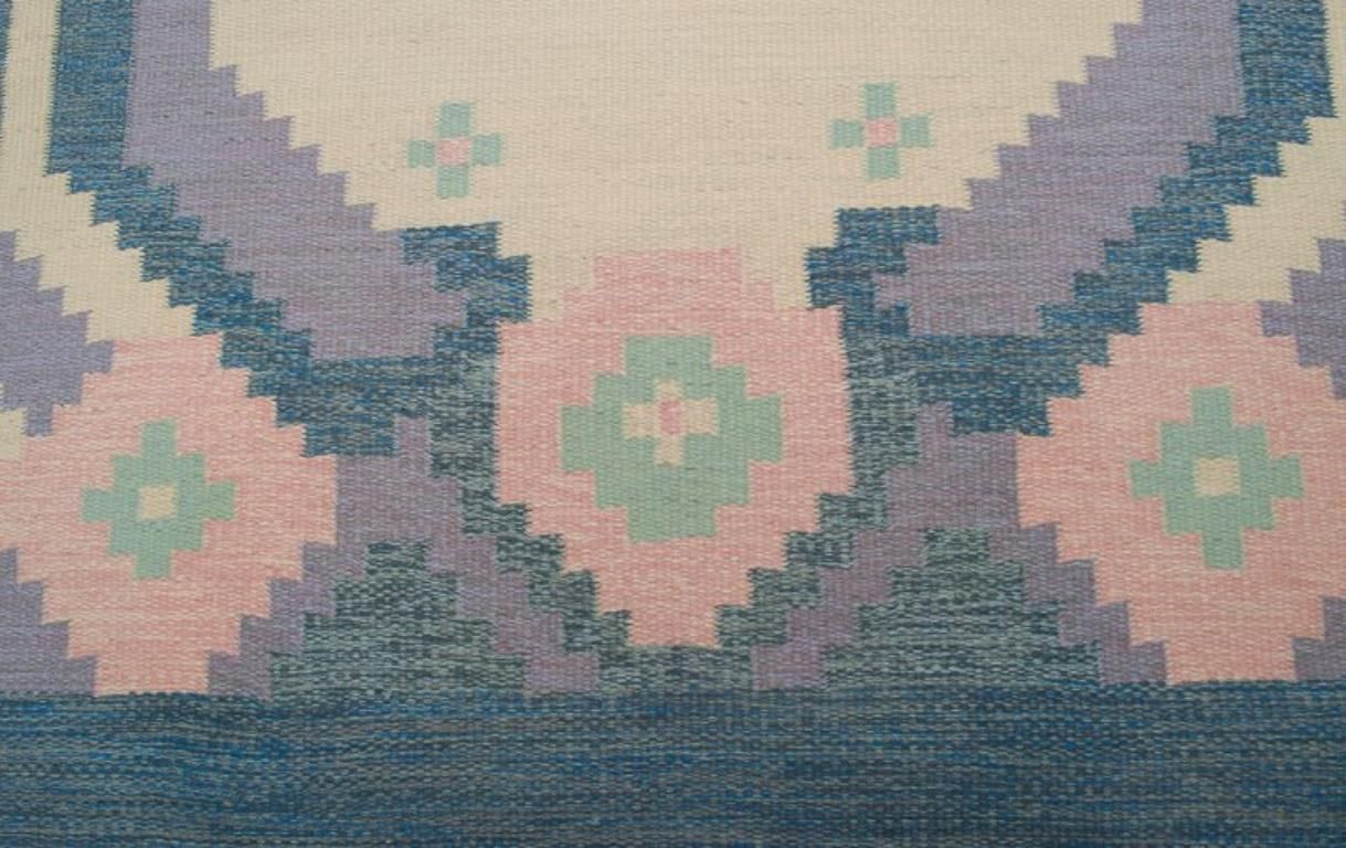 Swedish Carpet In Pure Wool. Geometric Pattern In Blue, White, And Pink Colors. photo 376.0