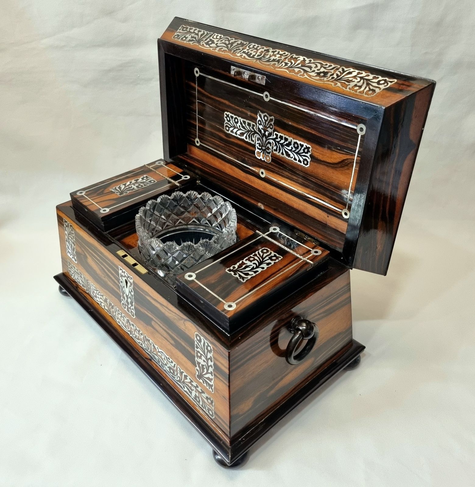 photo furniture An Exceptionally Fine Quality And Eye Catching Coromandel Tea Caddy Of Large Size & Sarcophagus Shape, Profusely Inlaid With Mother Of Pearl.