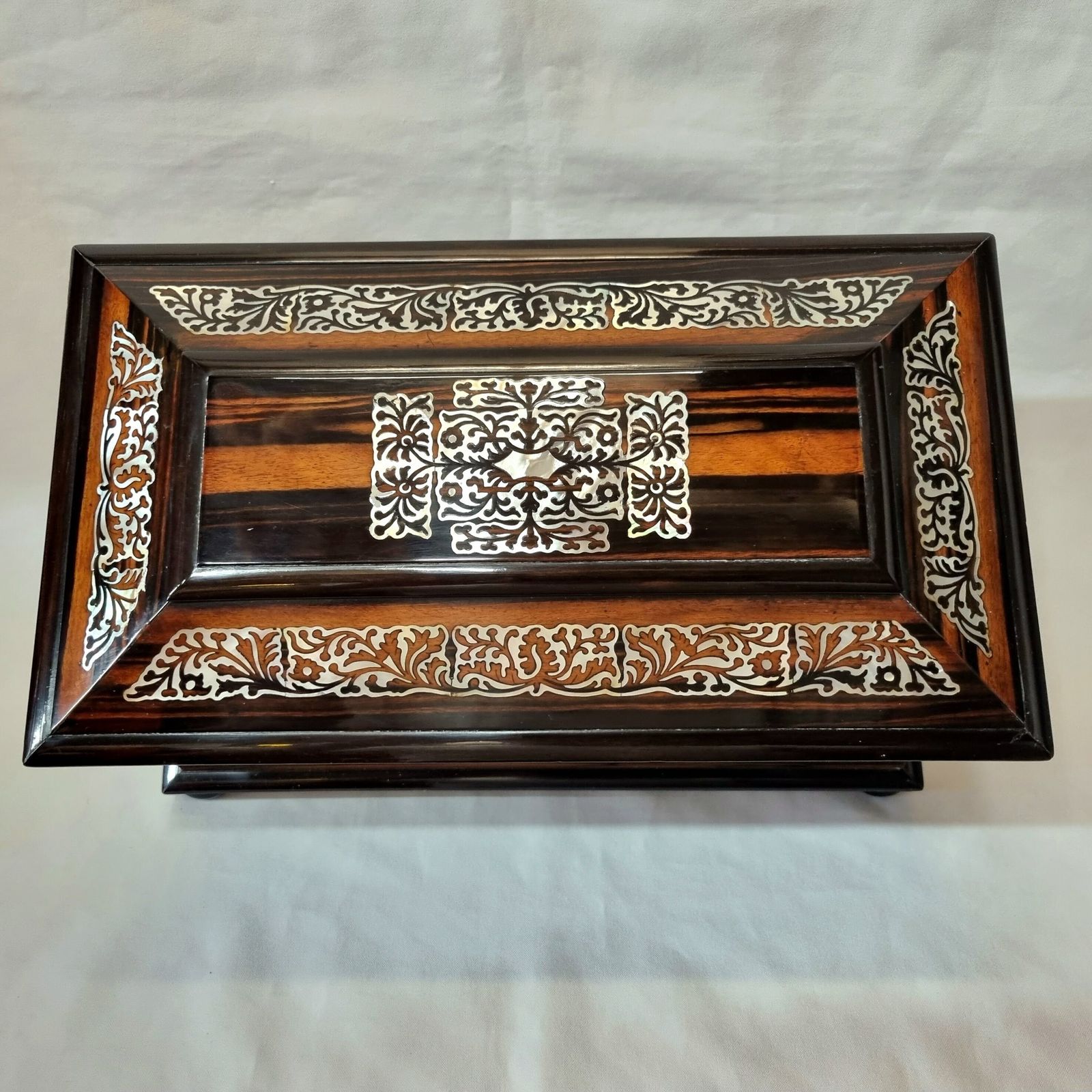 Home Decor An Exceptionally Fine Quality And Eye Catching Coromandel Tea Caddy Of Large Size & Sarcophagus Shape, Profusely Inlaid With Mother Of Pearl. photo