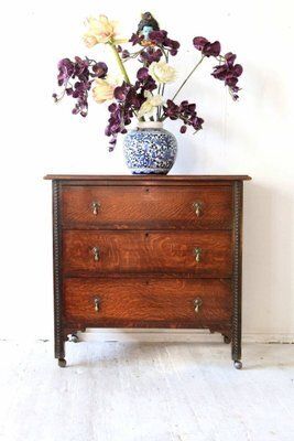 Antique Oak Chest Of Drawers On Castors With Brass Handles And Carved Details photo vinterior