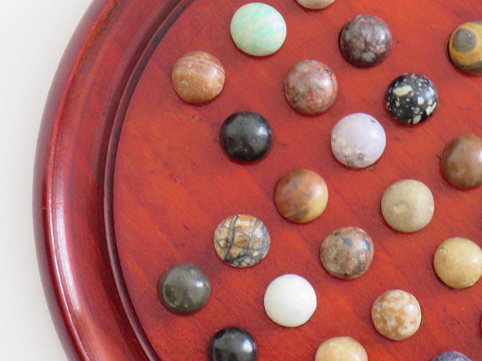 photo furniture Marble Solitaire Game With Hardwood Board And 33 Agate Stone Marbles, Circa 1925