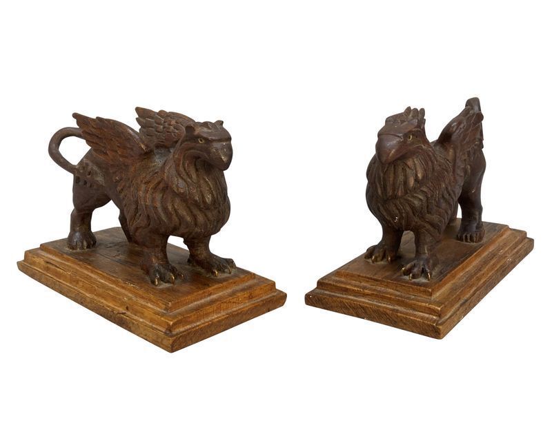 A Pair Of Carved Griffins On Plinths photo for sale