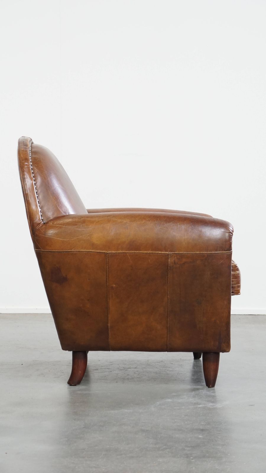 Characterful And Timeless Cowhide Design Armchair With Beautiful Round Shapes And Decorative Nails photo for sale