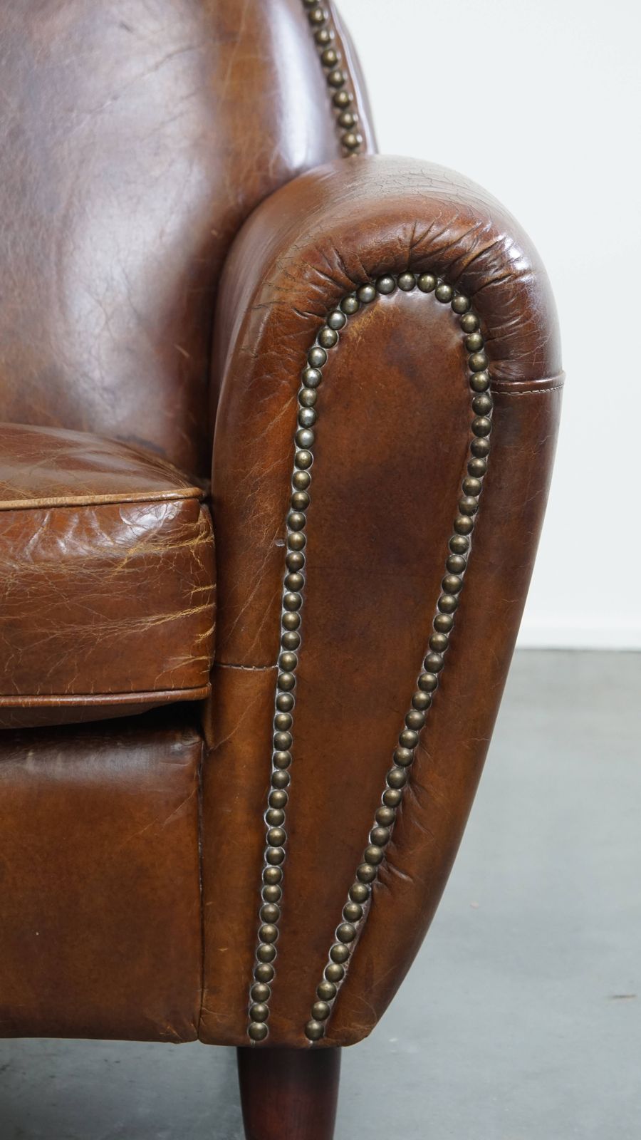 photo for sale Characterful And Timeless Cowhide Design Armchair With Beautiful Round Shapes And Decorative Nails