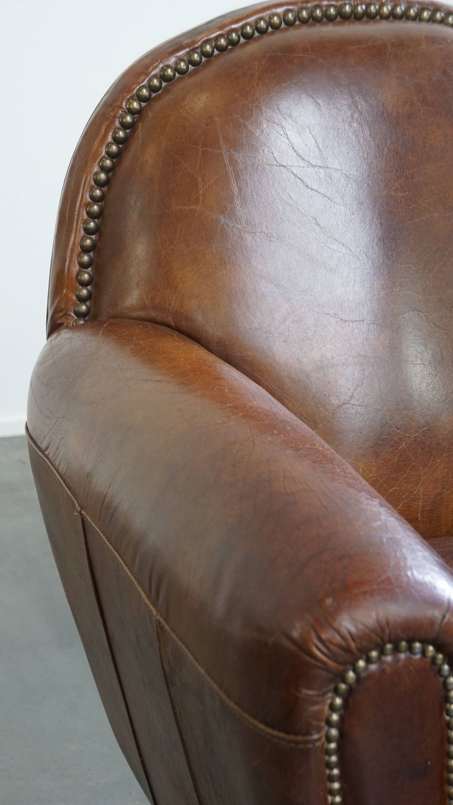 Furniture Characterful And Timeless Cowhide Design Armchair With Beautiful Round Shapes And Decorative Nails photo