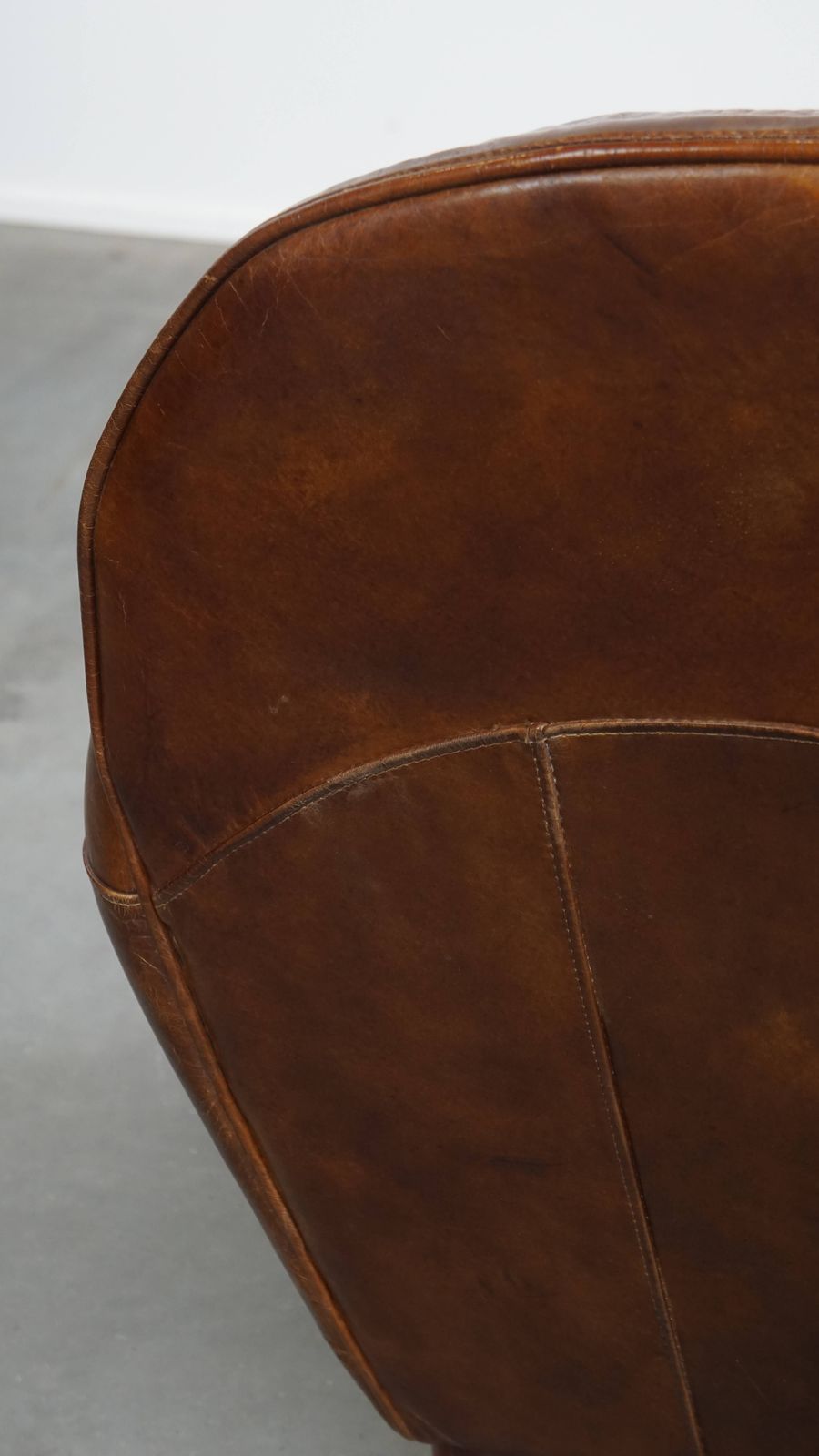 photo vinterior Characterful And Timeless Cowhide Design Armchair With Beautiful Round Shapes And Decorative Nails