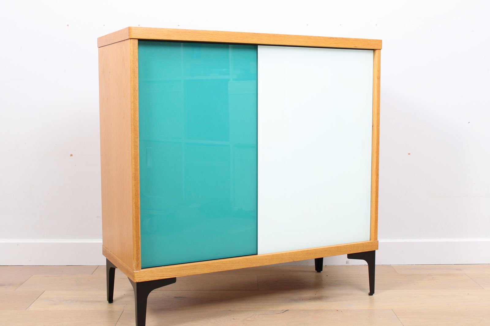 A Vintage Mid Century Bookcase With Teal And White Sliding Doors 1 Of 2 photo buy