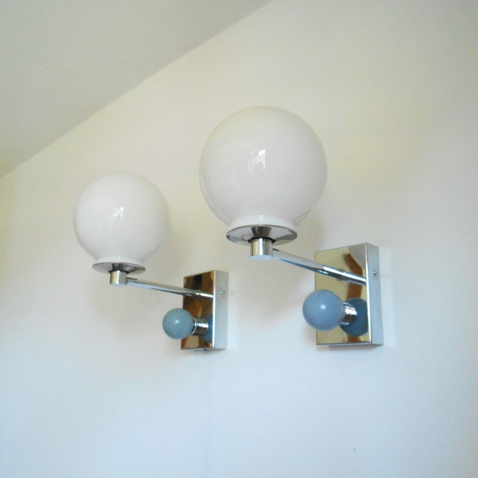 A Pair Of Unique Silver Chrome Wall Lamps With White Glass Globe Shades