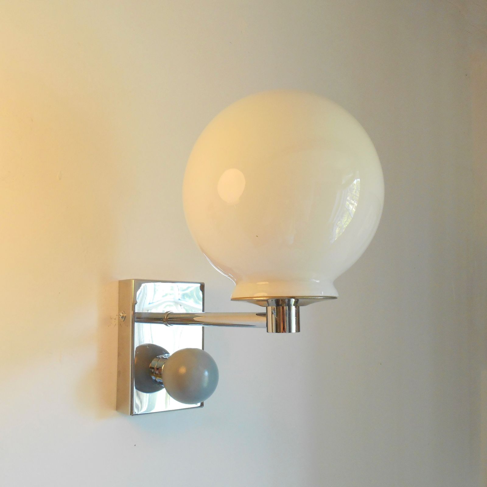 photo vinterior A Pair Of Unique Silver Chrome Wall Lamps With White Glass Globe Shades