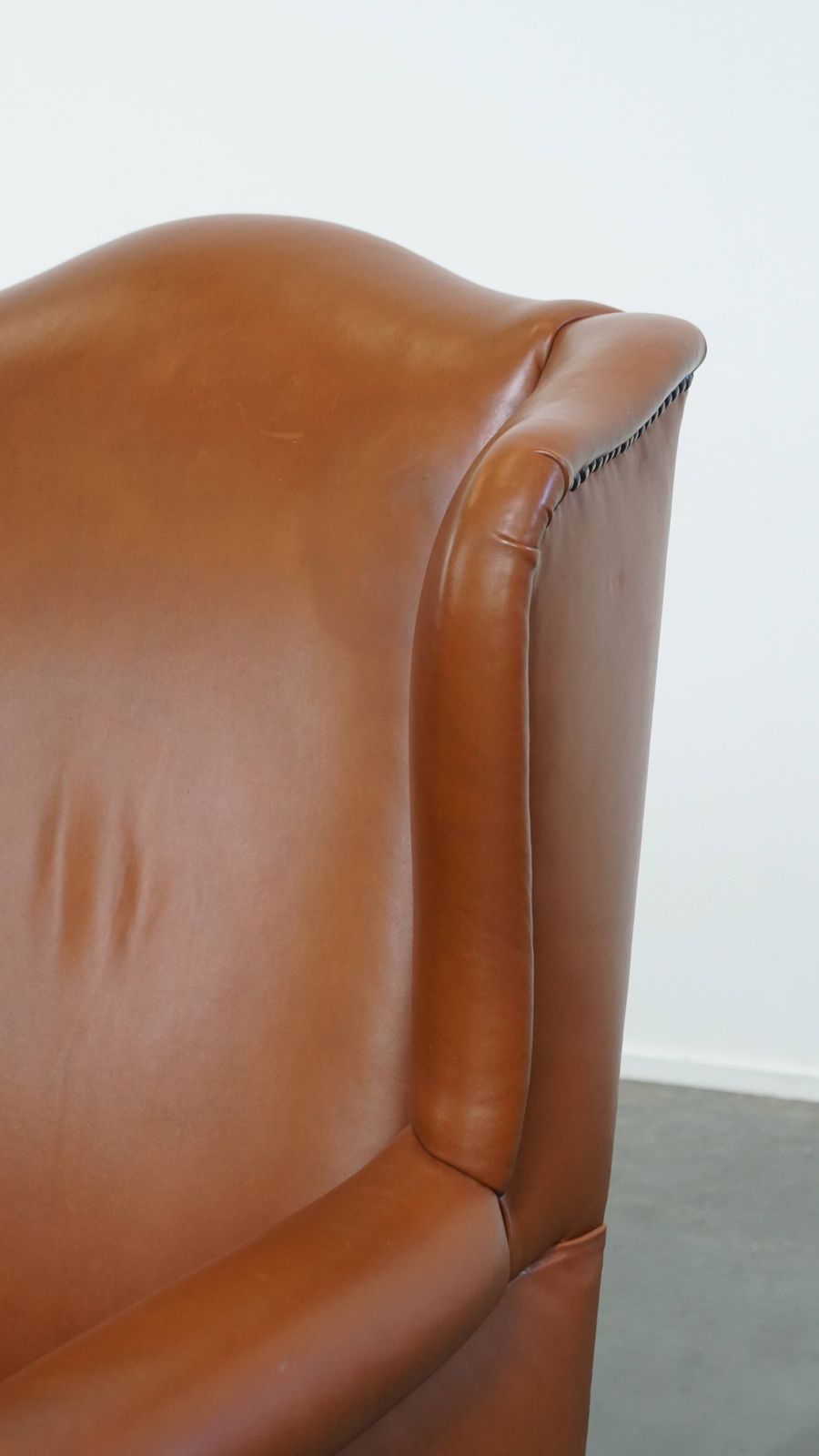 Furniture Stylish And In Good Condition Cognac Colored Cowhide Armchair In English Style With Decorative Nails photo
