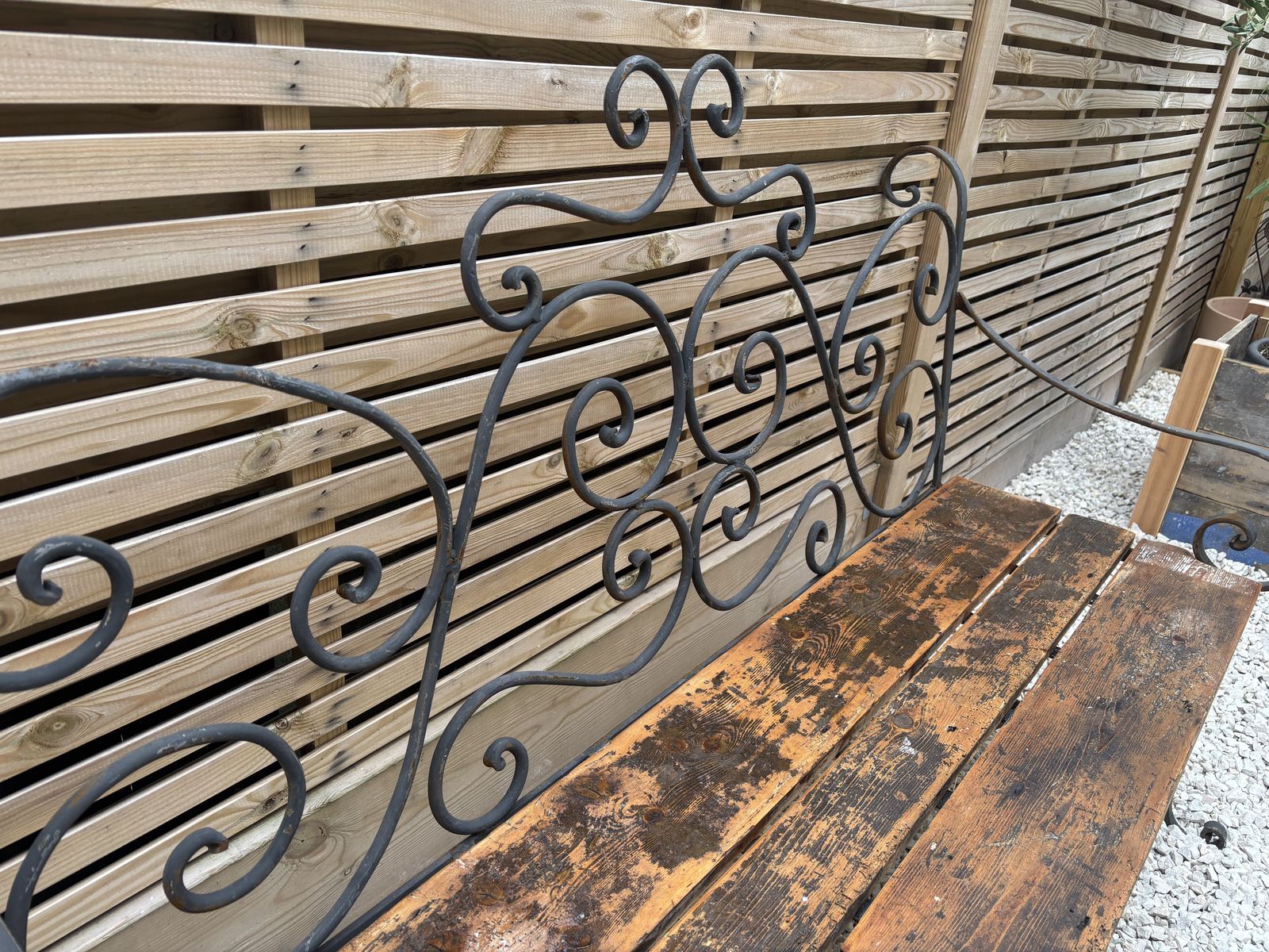 French Wrought Iron Garden Bench With Weathered Wooden Seat photo vinterior