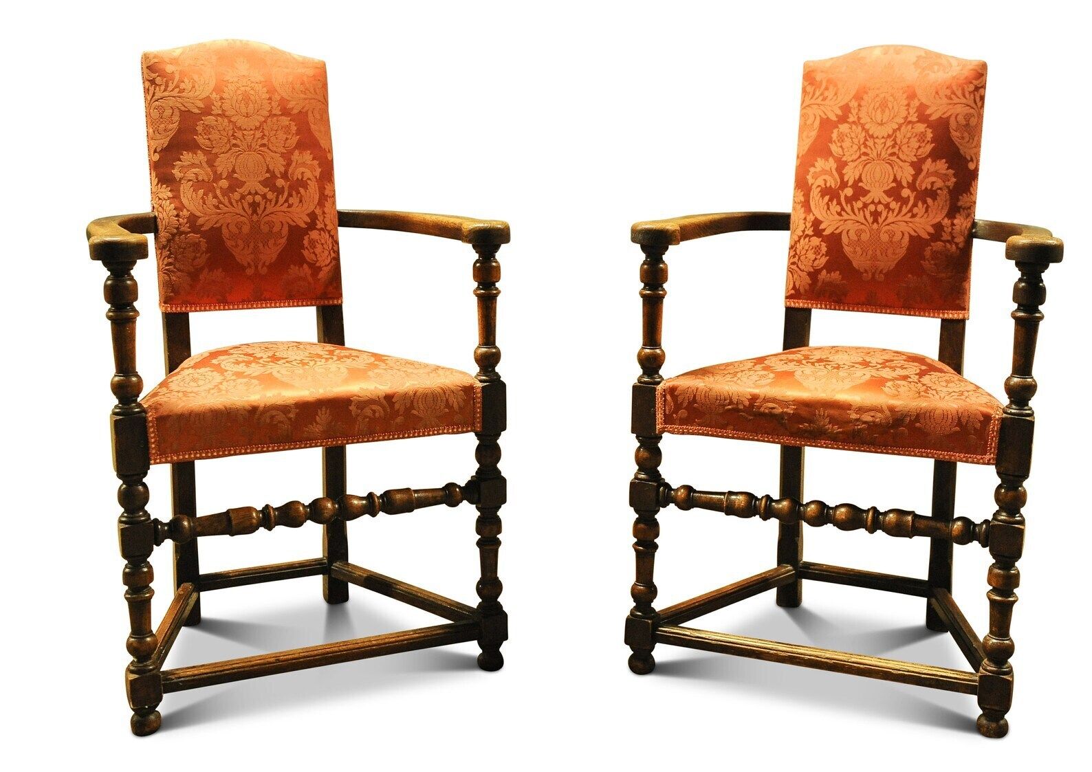 A Pair Of Oak Turned Elbow Chairs In An Early English Style With Rails And Stretchers With A Burnt Orange Damask Upholstery