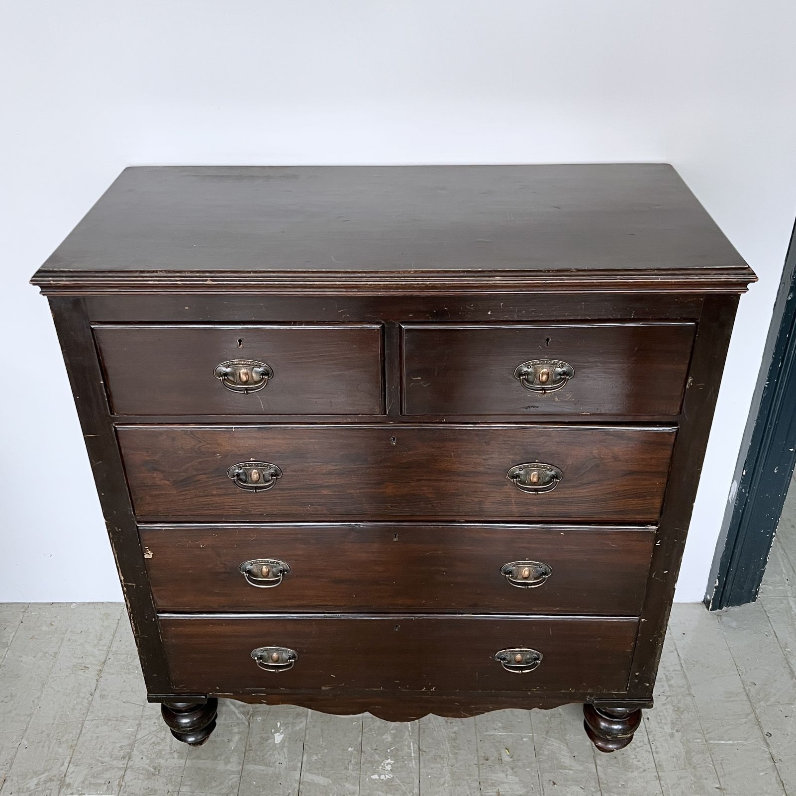 photo furniture Dark Stained Wooden Chest Of Drawers With Original Handles