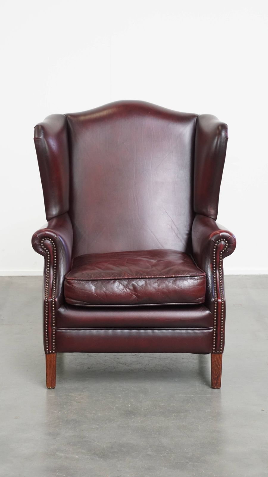 Beautiful And Comfortable Burgundy Red Cowhide Wing Chair In English Style With A Wonderful Patina photo furniture