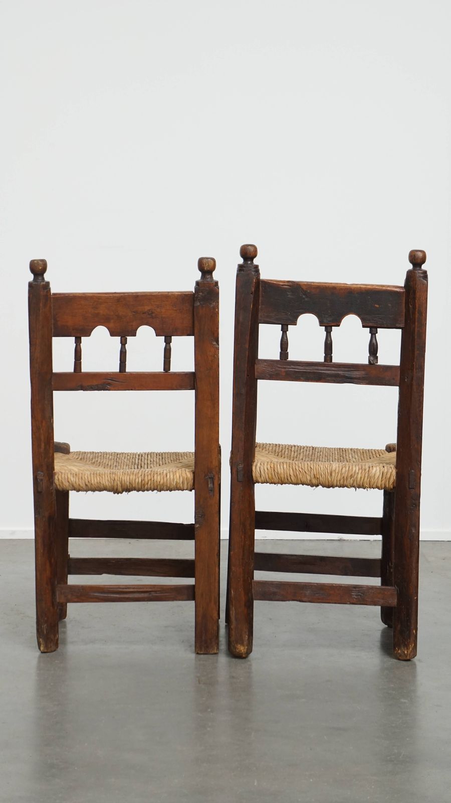Nice Unique Set Of 2 Antique Spanish Farm Chairs With Woven Wicker Seat And Beautiful Wood Carving photo for sale