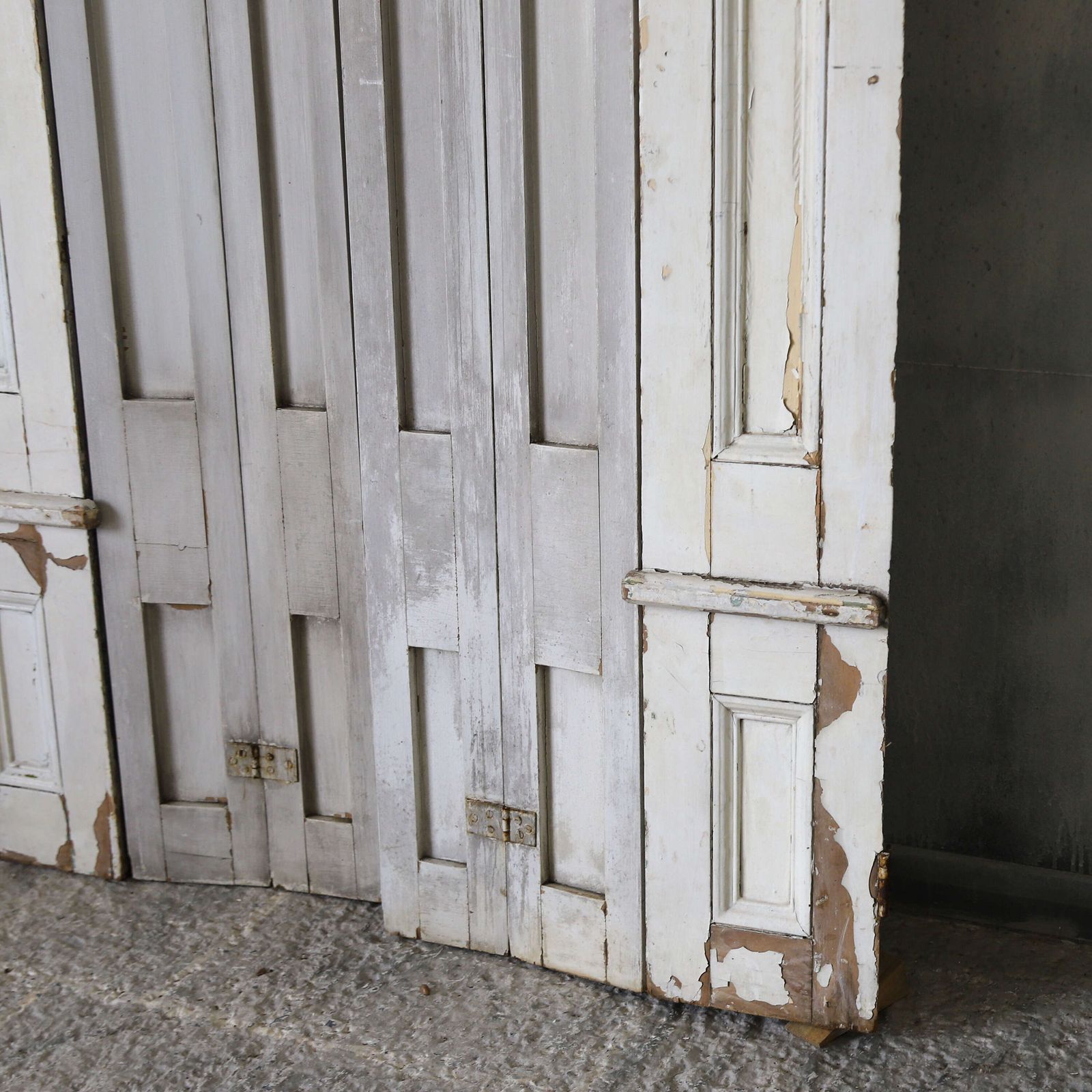 Pair Of Antique Panelled Tri Folding Shutters In Original Cream Paint photo vintage
