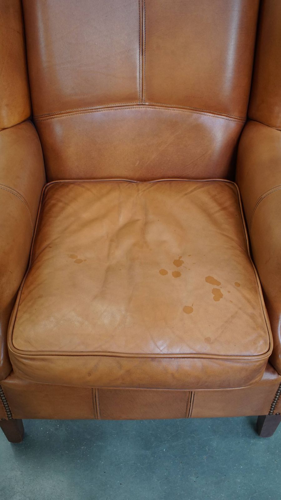 Classic And Unique Cowhide Wing Chair Finished With Decorative Nails And Beautiful Details photo vinterior