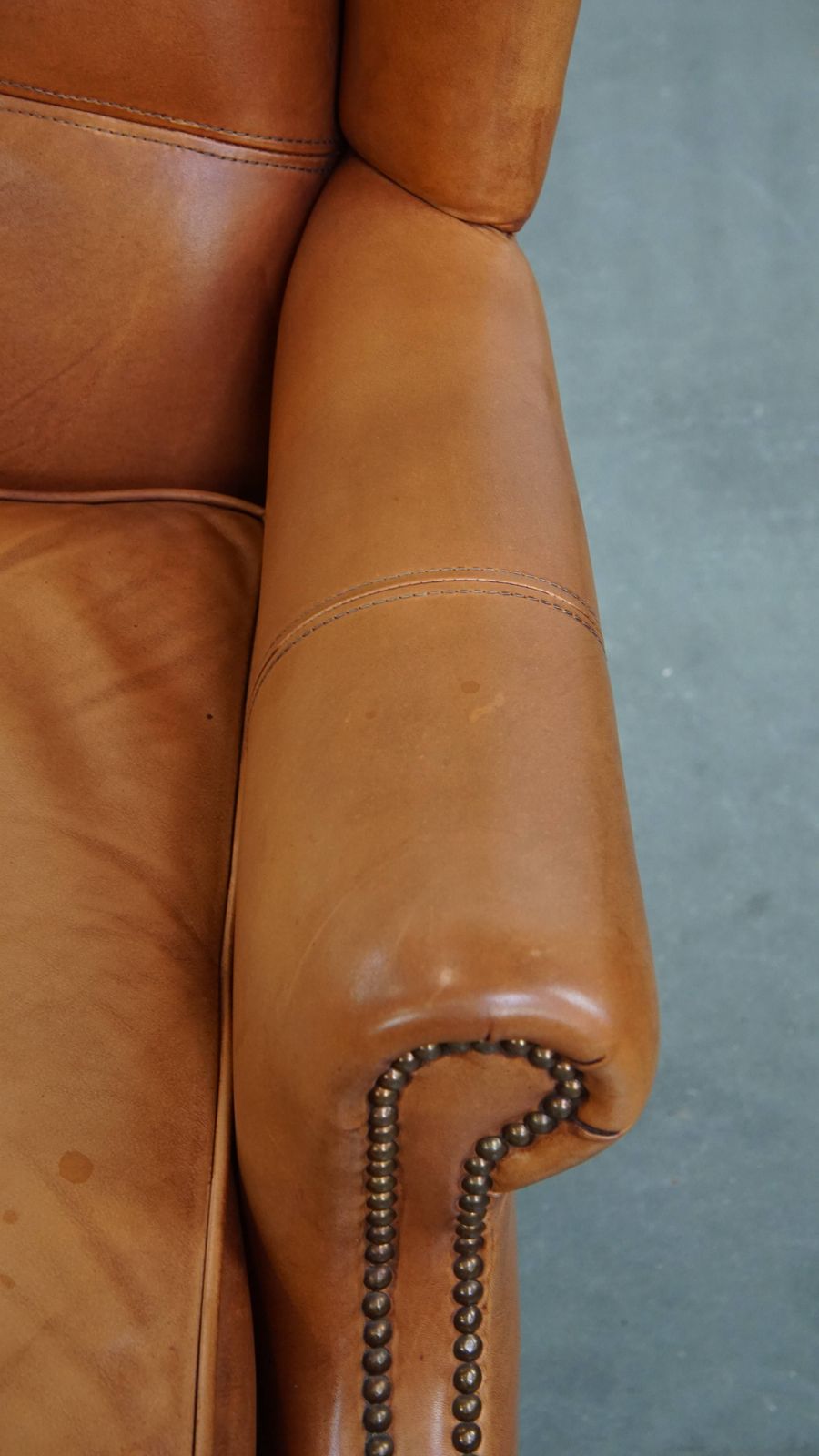 Classic And Unique Cowhide Wing Chair Finished With Decorative Nails And Beautiful Details photo vintage