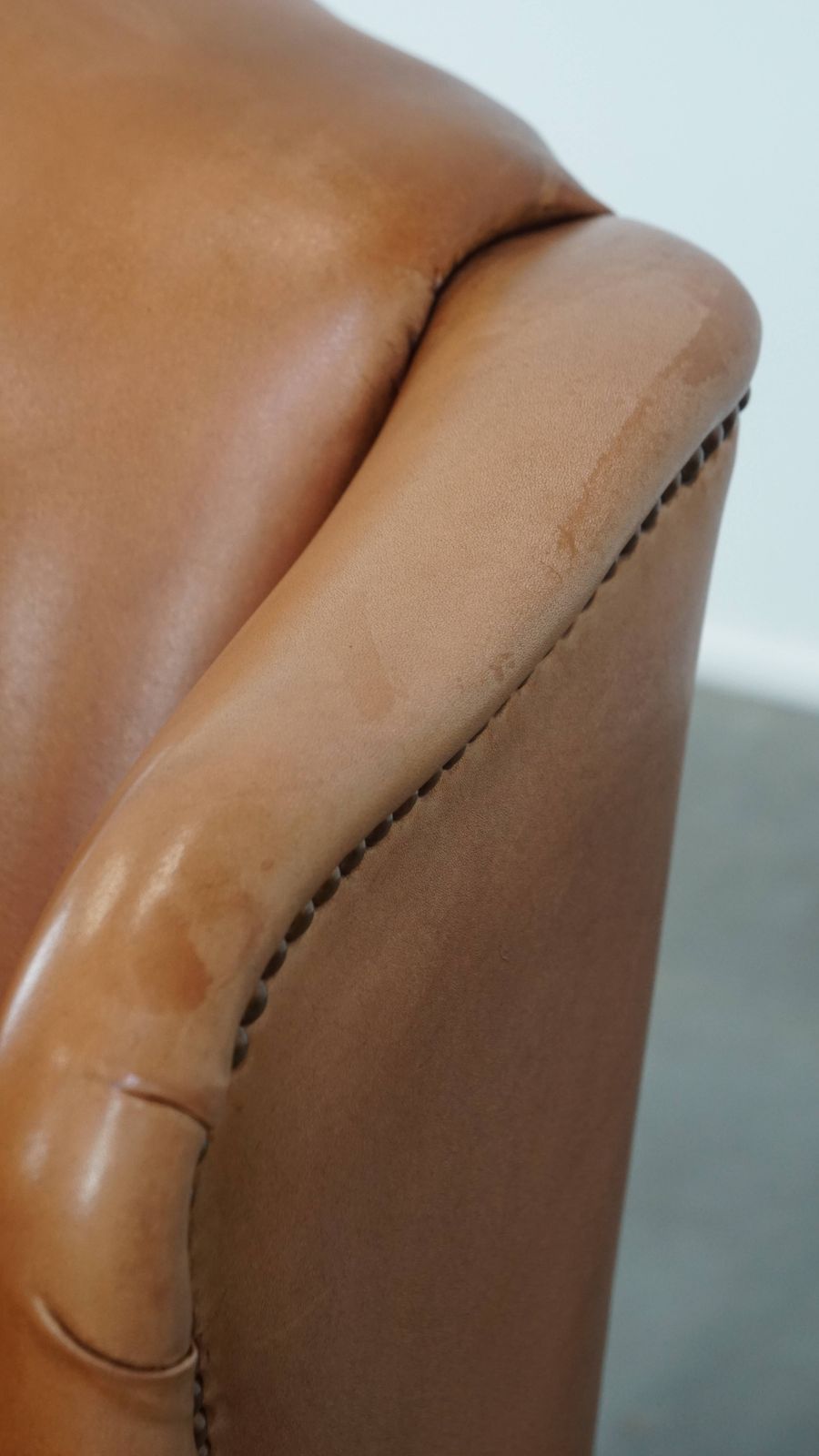 Furniture Unique And Comfortable Wing Chair Made Of Cowhide Leather Finished With Decorative Studs And Beautiful Details photo