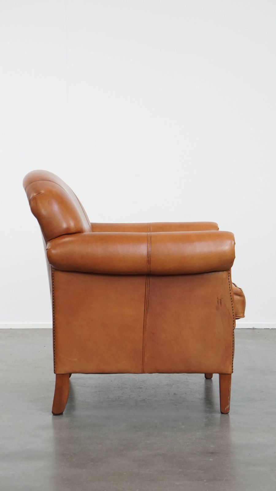 Beautiful And Comfortable Cowhide Leather Armchair In A Warm Cognac Color Finished With Decorative Nails photo for sale