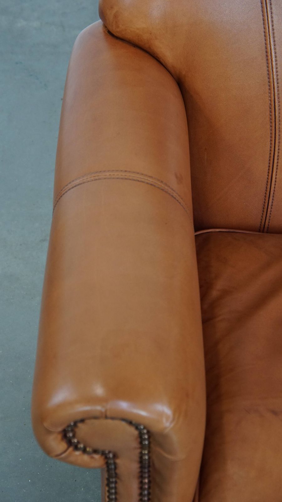 Beautiful And Comfortable Cowhide Leather Armchair In A Warm Cognac Color Finished With Decorative Nails photo buy