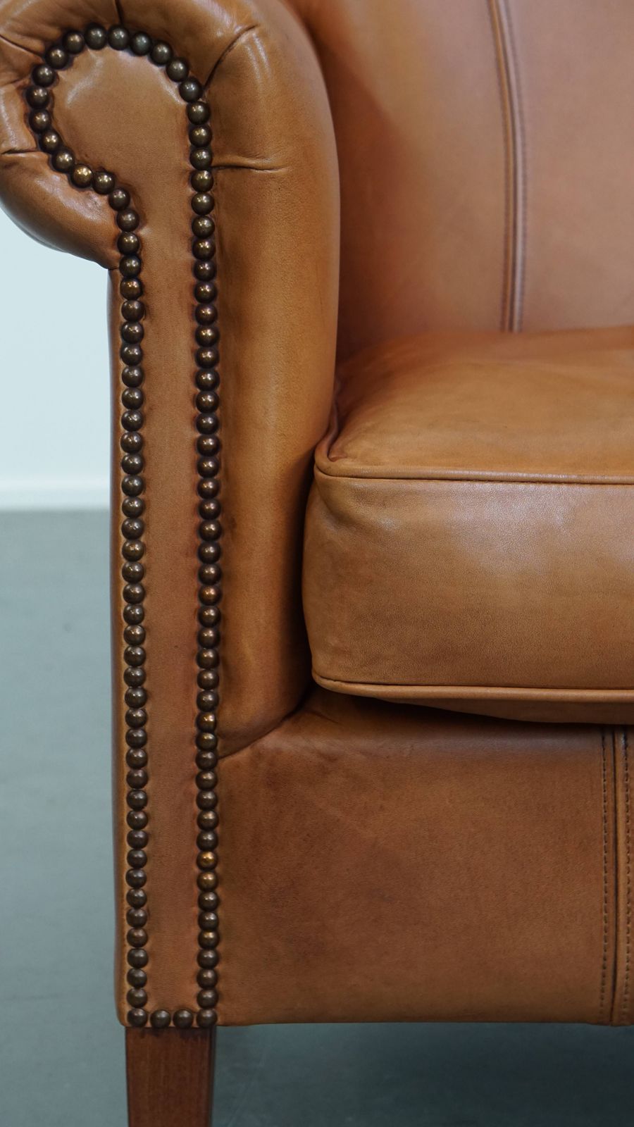 Furniture Beautiful And Comfortable Cowhide Leather Armchair In A Warm Cognac Color Finished With Decorative Nails photo