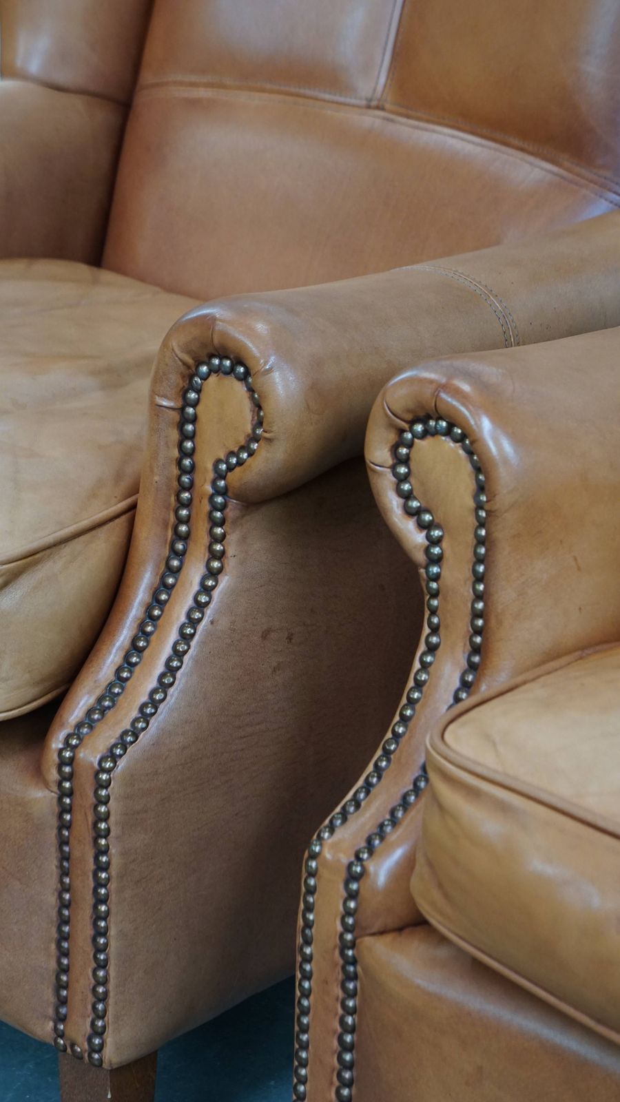 Furniture Classic And Unique Set Of 2 Cowhide Wing Chairs Finished With Decorative Nails And Beautiful Details photo
