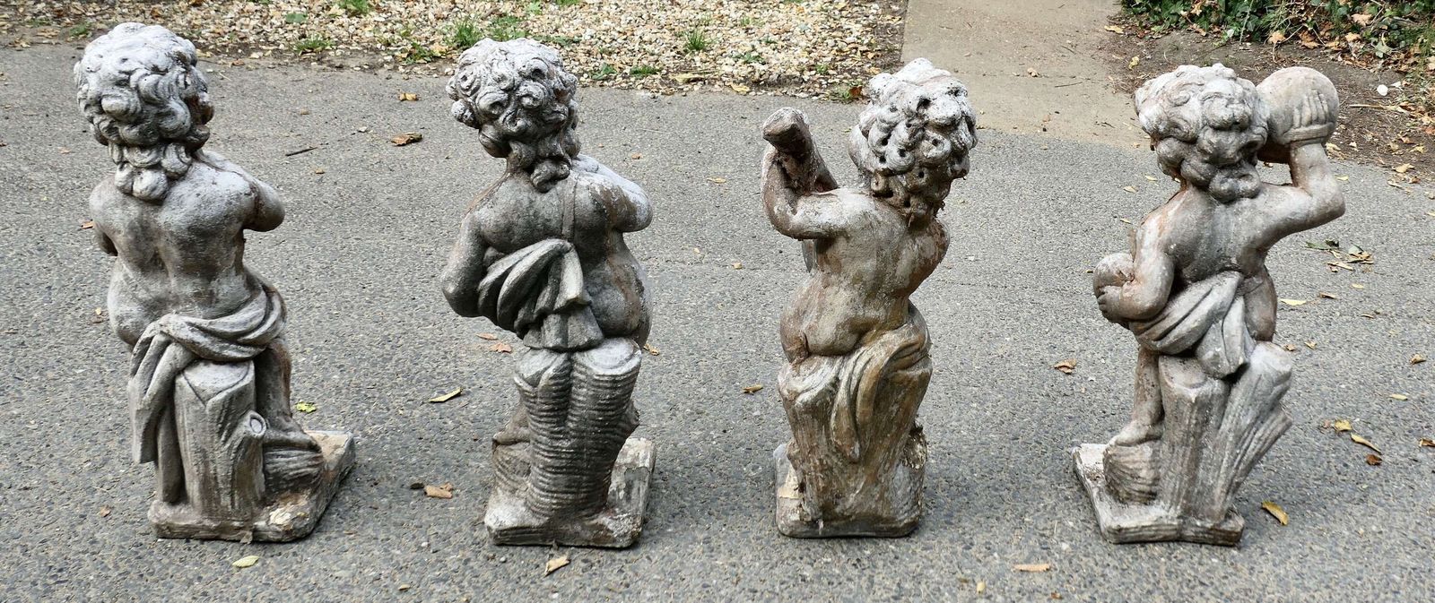 A Set Of 4 Weather Worn Cherub Statues With Instruments photo vinterior