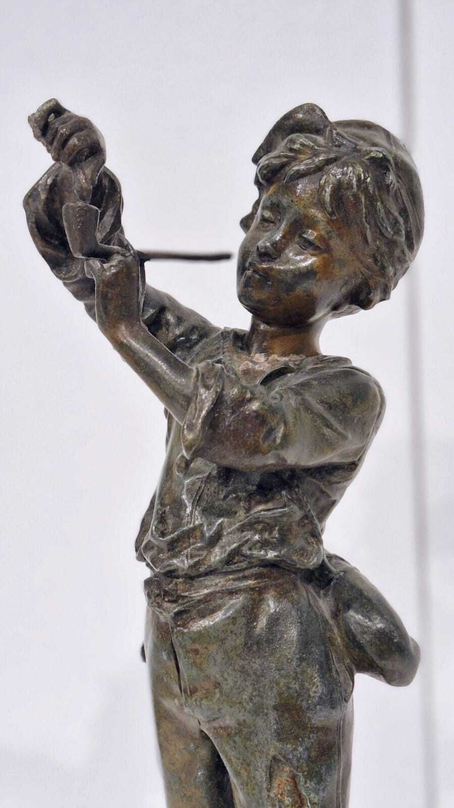 A French Spelter Statue Of A Boy Lighting A Pipe photo for sale
