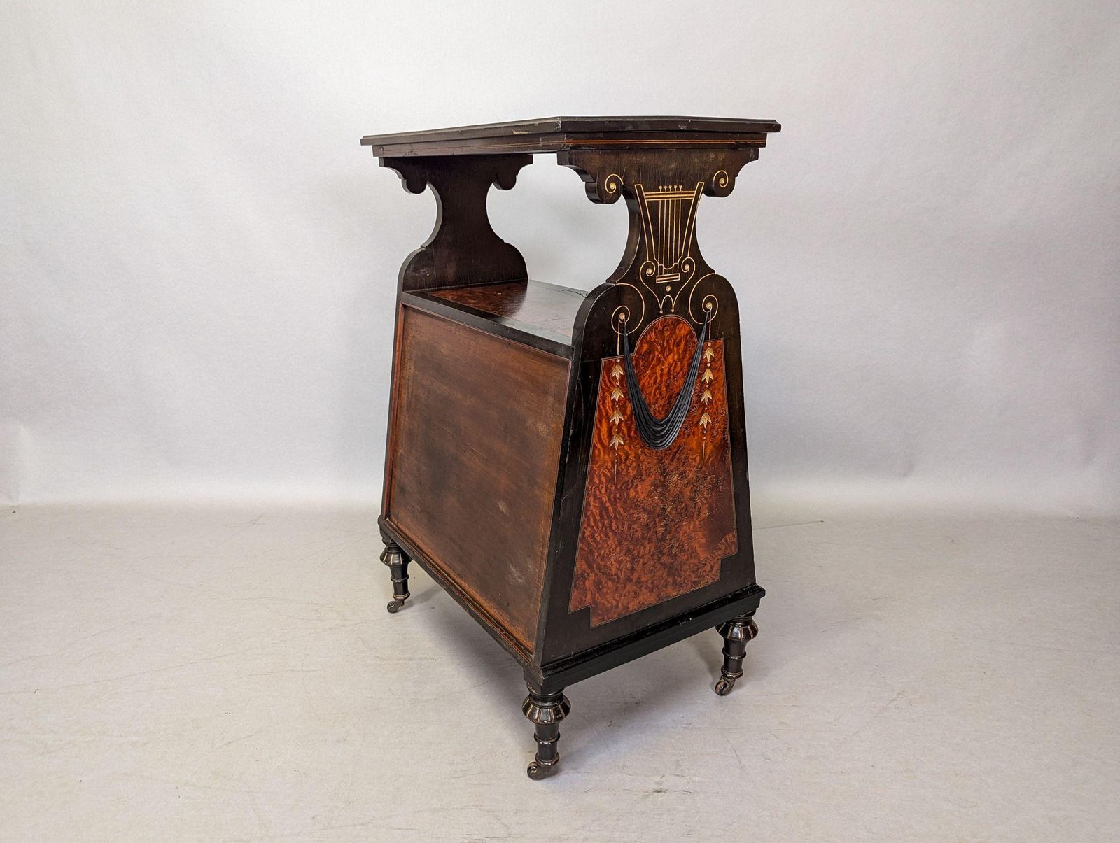 photo furniture An Aesthetic Movement Amboyna And Ebonized Music Cabinet With Gilt Decoration