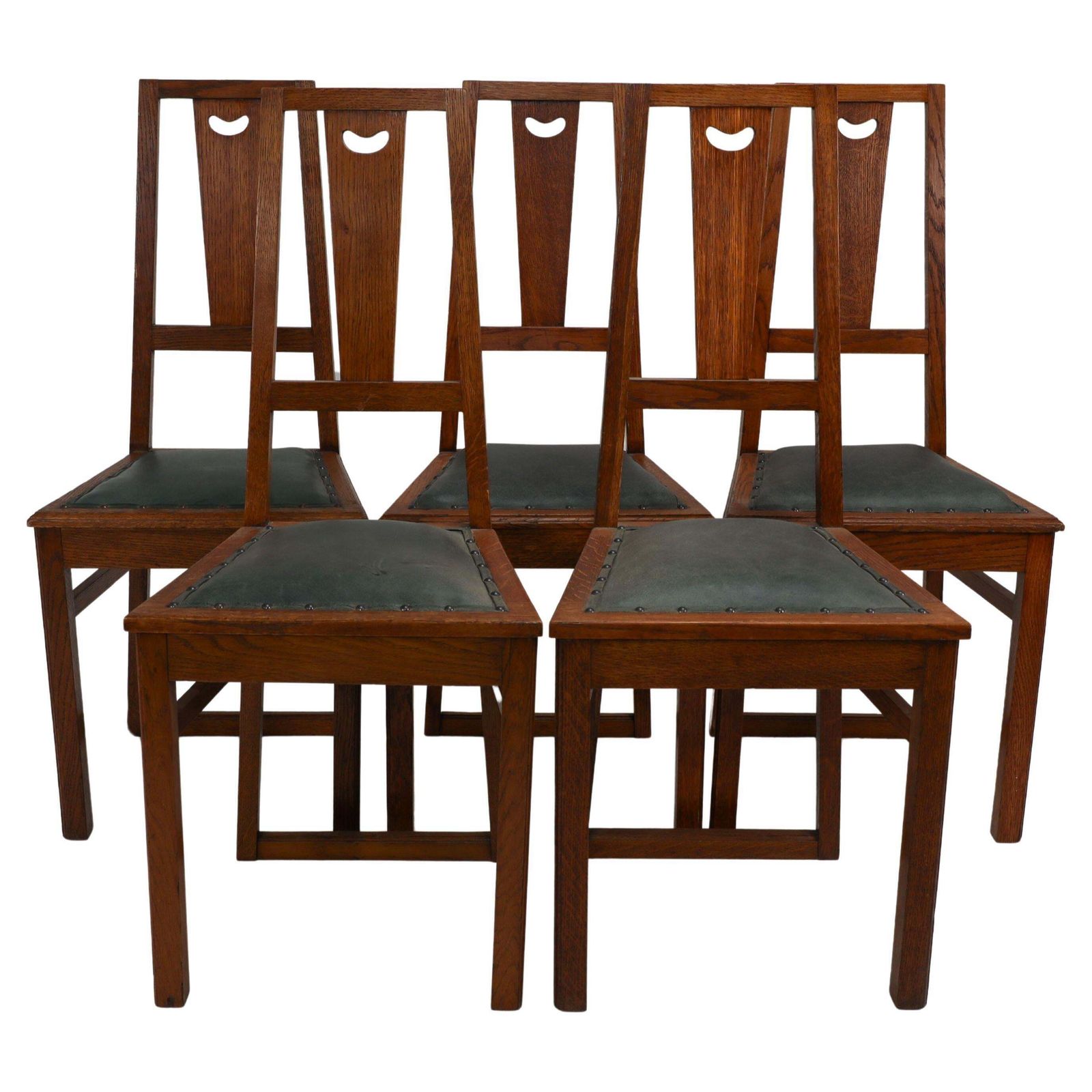E A Taylor. A Set Of Five Arts And Crafts Oak Side Chairs With Heart Cut Outs.