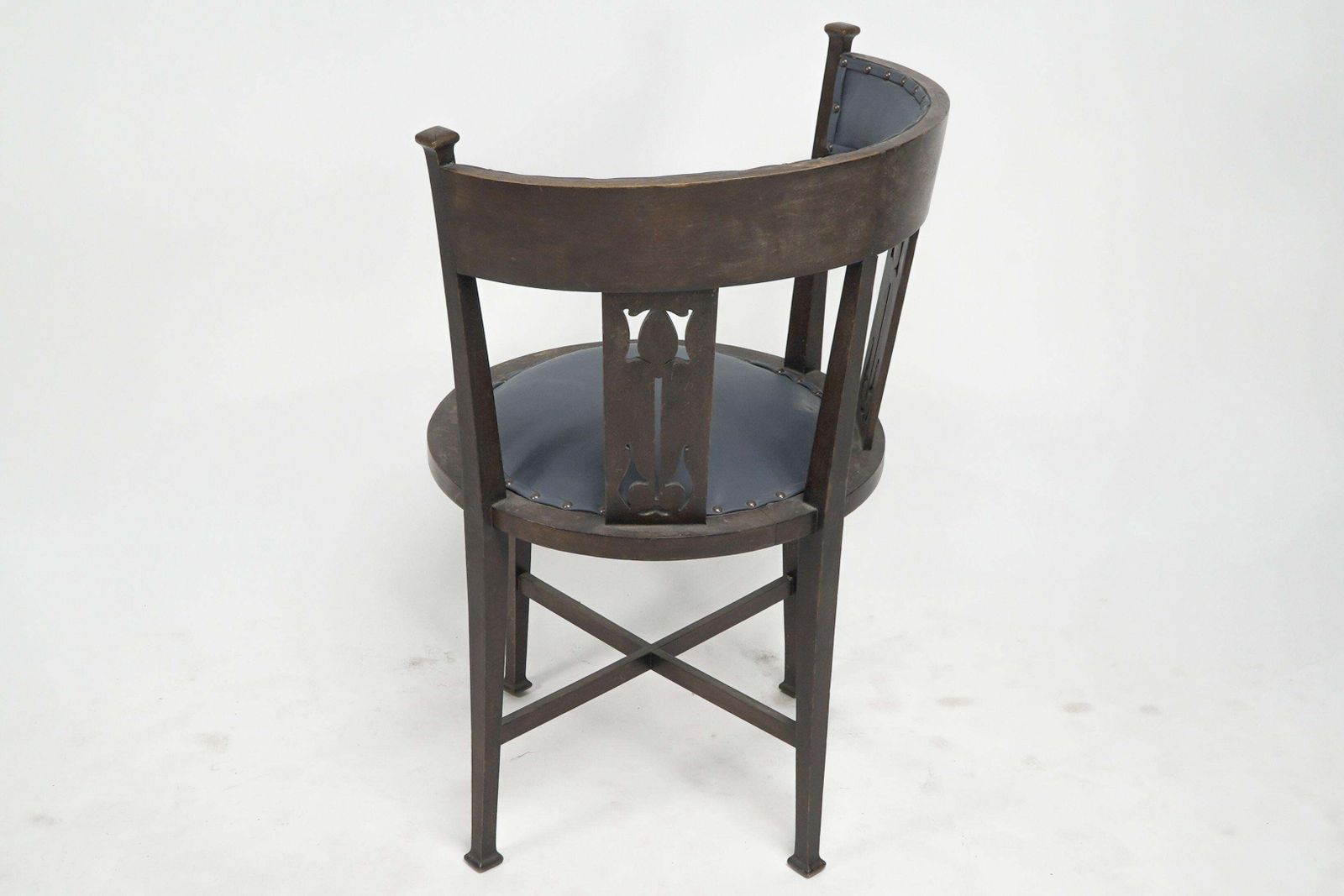 An Arts And Crafts Mahogany Tub Chair With Stylized Floral Cut Outs photo for sale