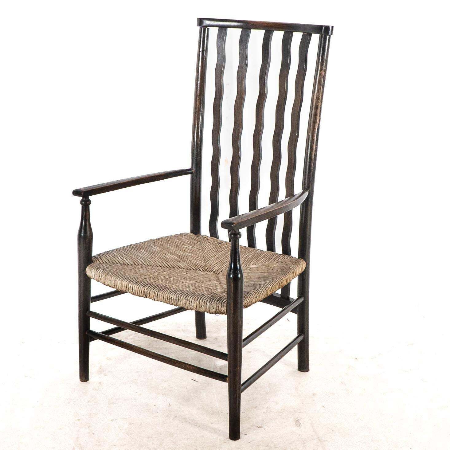 Liberty & Co. An Arts & Crafts Rush Seat Armchair With Wavy Shaped Back Slats photo for sale