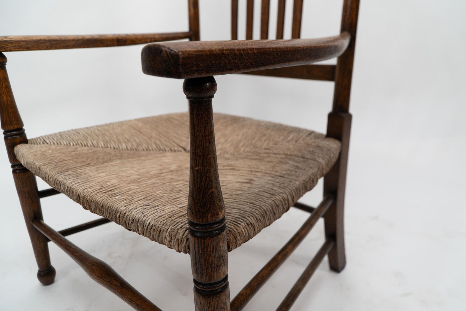 photo furniture Liberty And Co. An Arts And Crafts Rush Seat Armchair