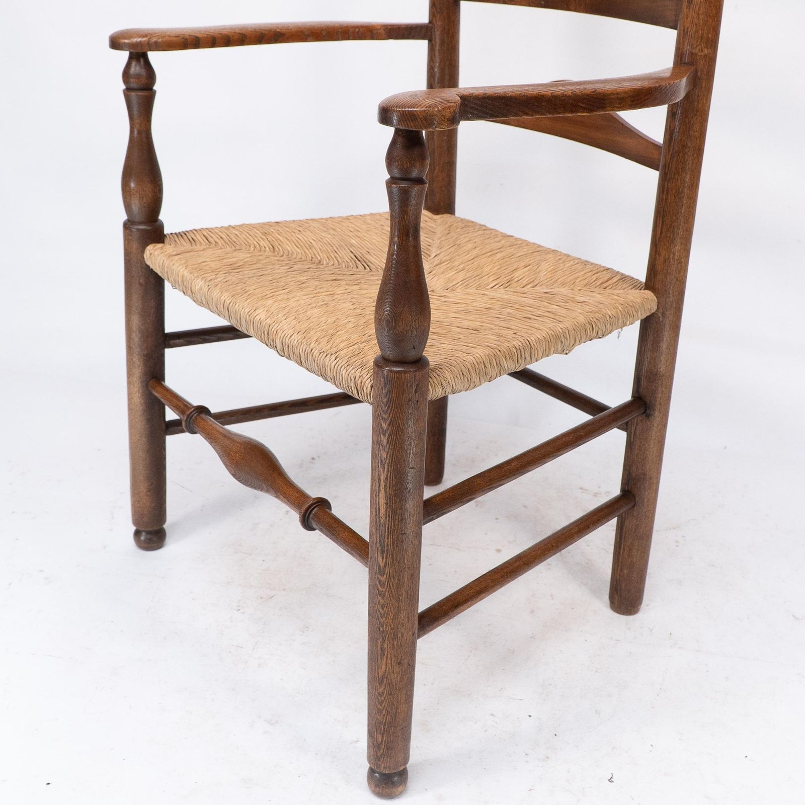 photo vintage C R Ashbee Attr. An Arts & Crafts Oak Ladder Back Armchair With Re Rushed Seat