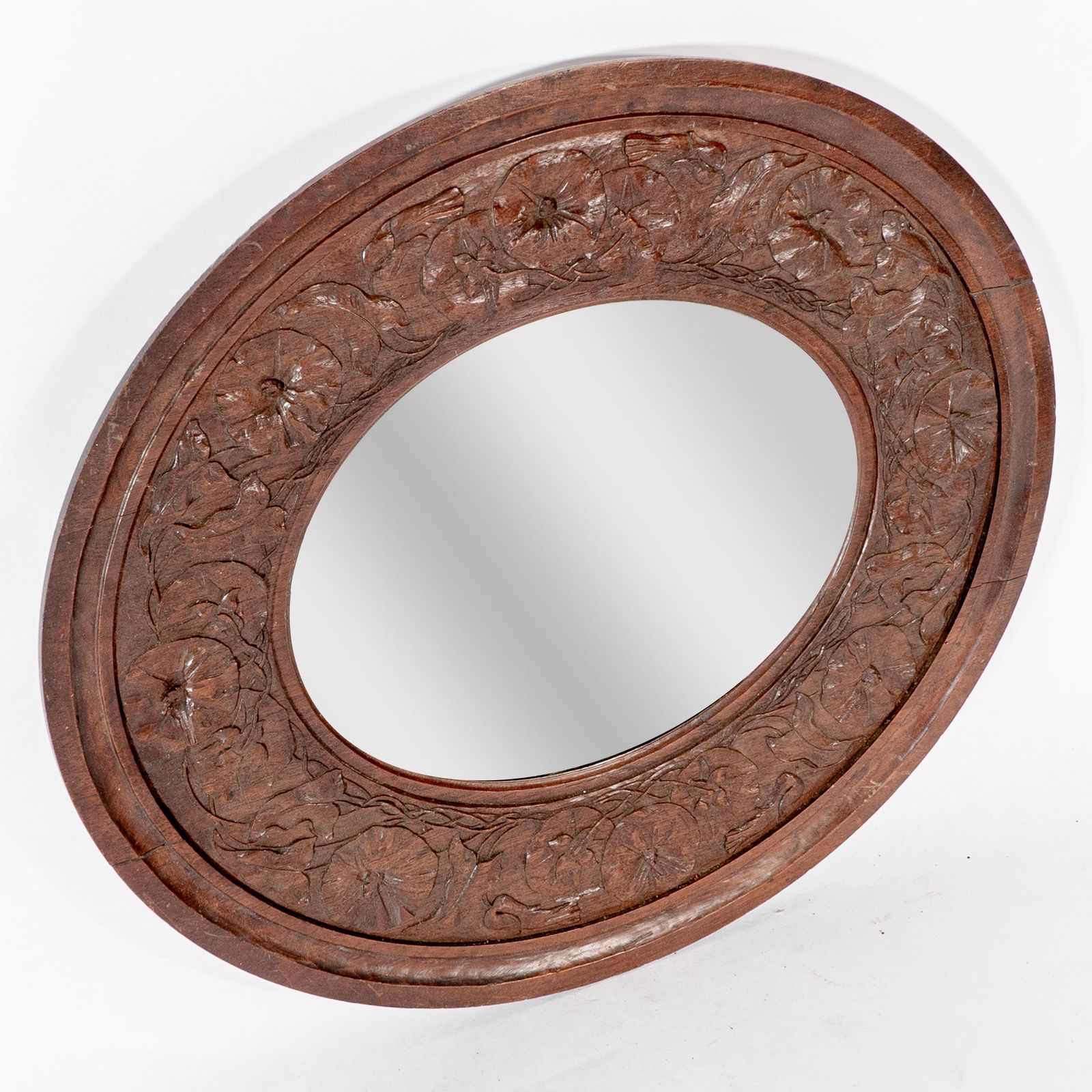 An Arts & Crafts Walnut Circular Mirror With Stylized Floral Carved Decoration photo furniture