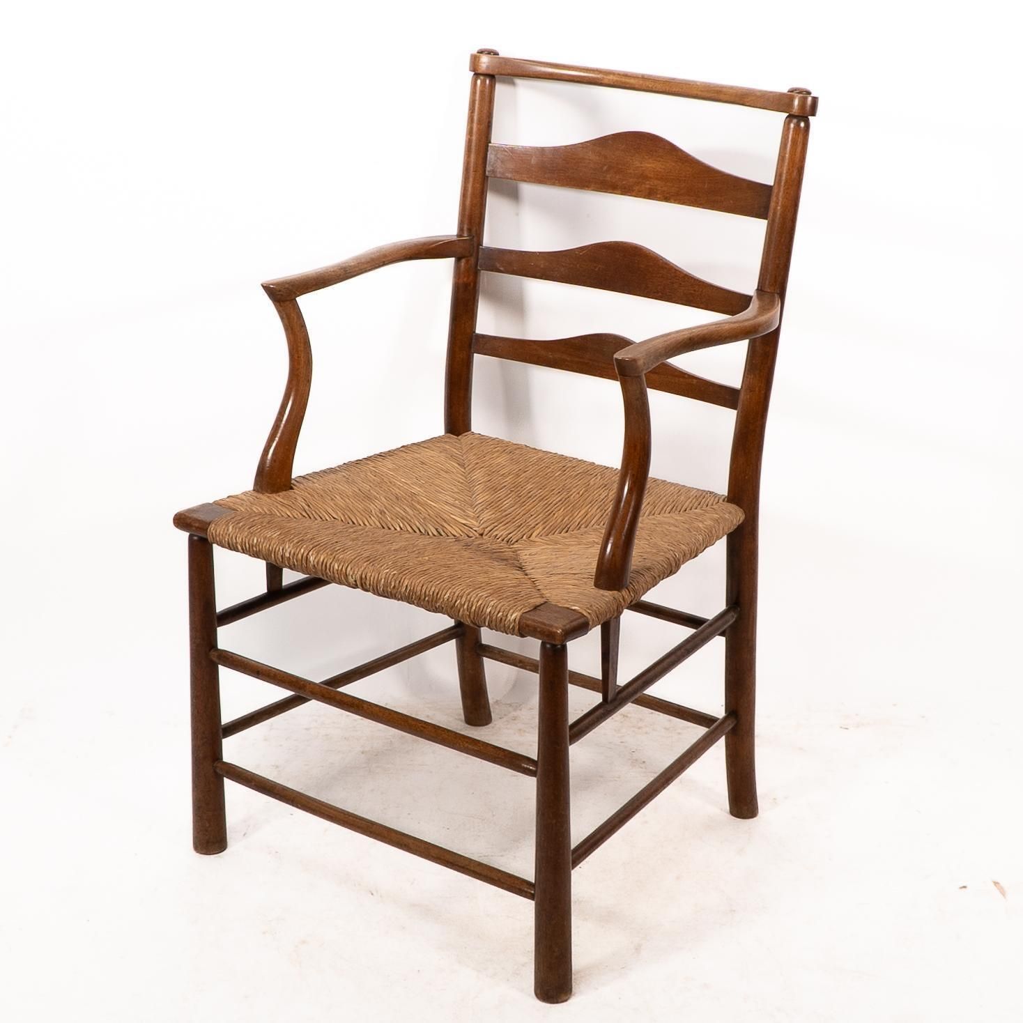 C R Ashbee. An Arts And Crafts Rush Seat Ladder Back Armchair photo for sale