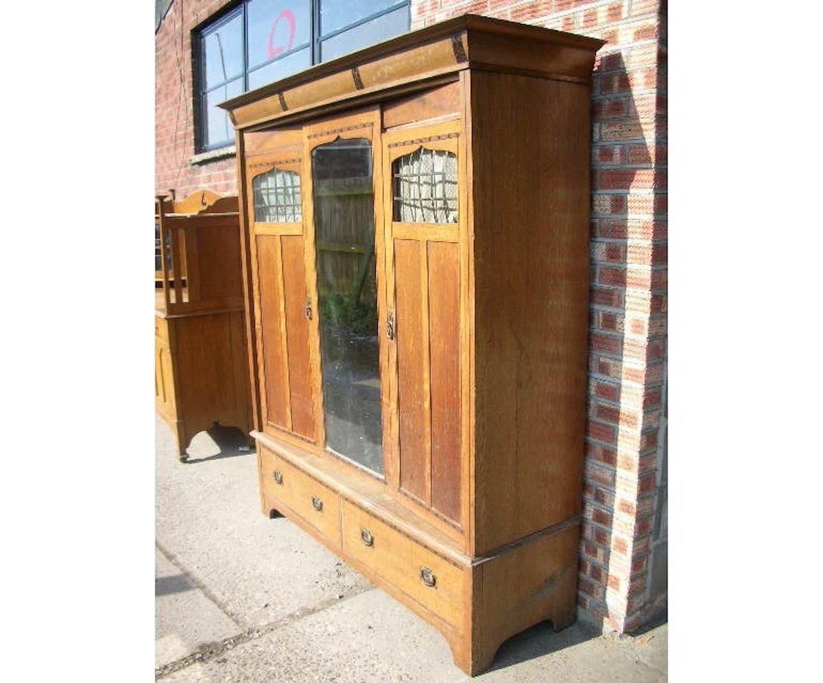 Gillows. An Arts & Crafts Oak Treble Wardrobe With Ebony Floral Inlays photo furniture